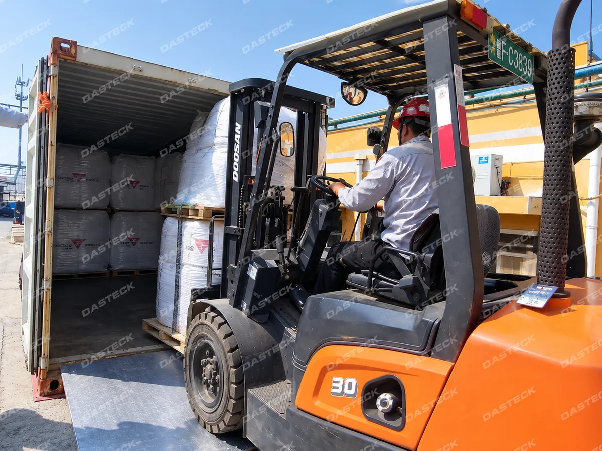 Dasteck worker loading packaged Thiourea Dioxide into an export container